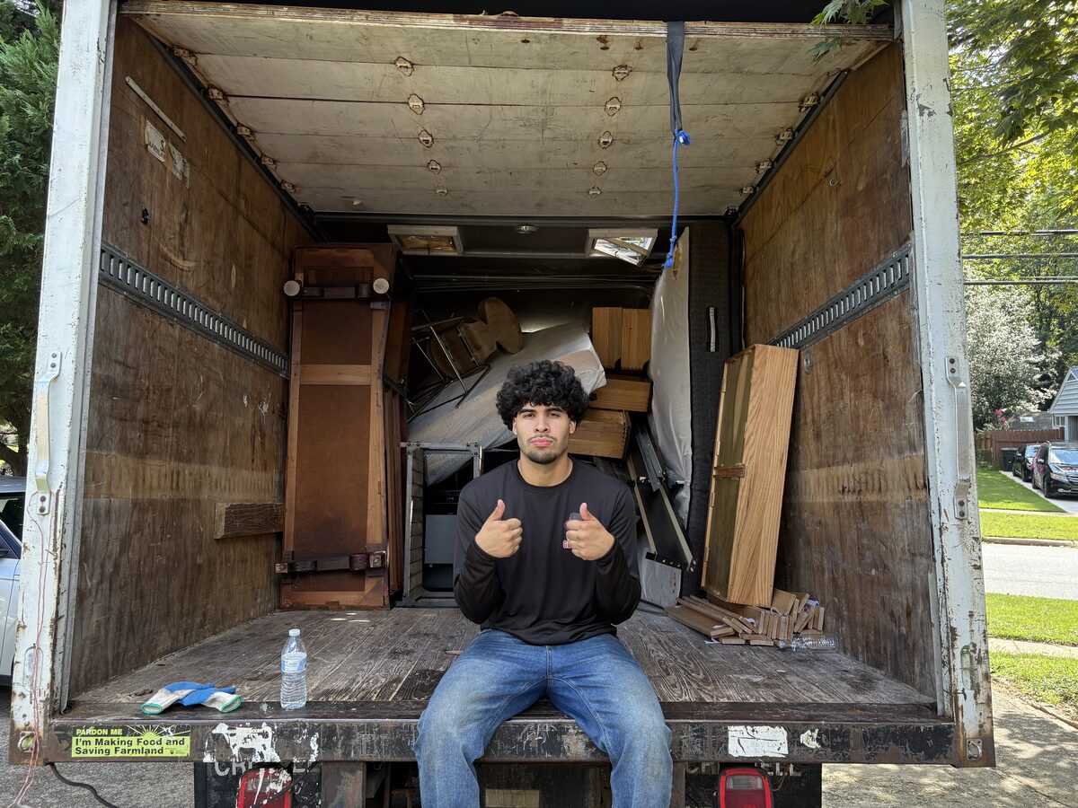 Crew member giving thumbs up at loaded truck